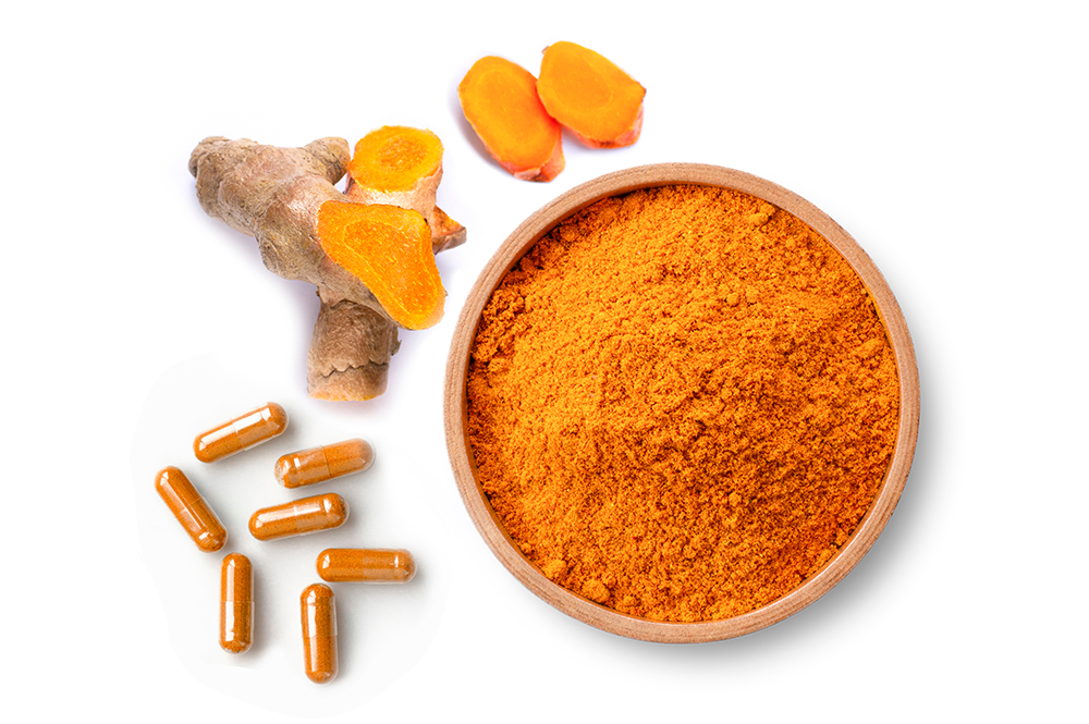 turmeric powder in a bowl and capsule